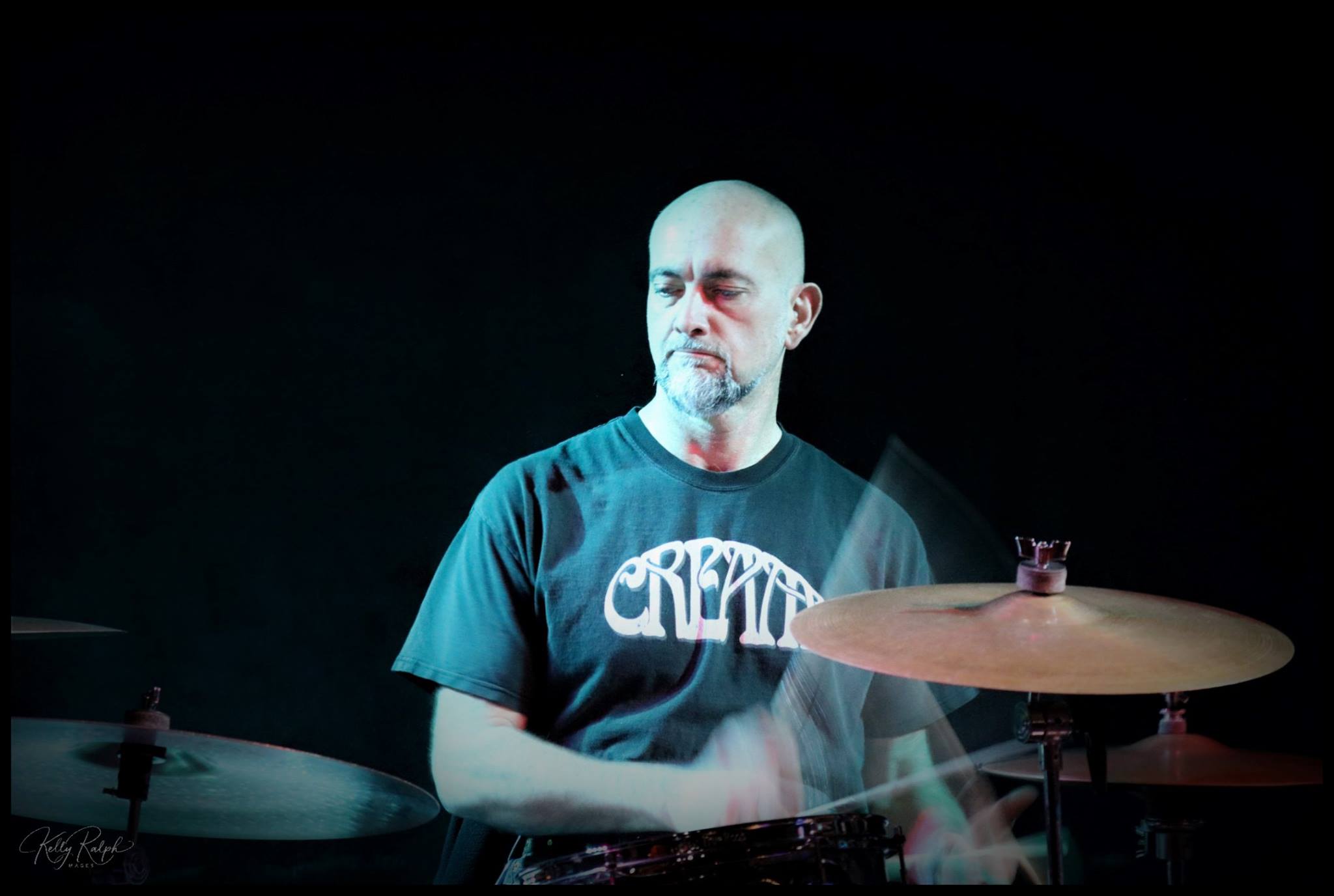 Man playing acoustic guitar in backyard