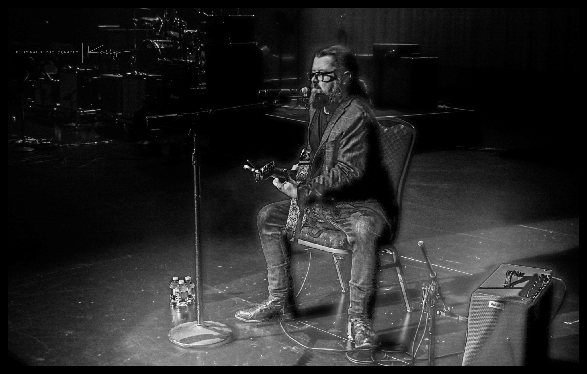 Artist playing violin in low lighting